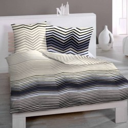 Linge de lit BANTU sur un lit, housse de couette et taies en satin de coton